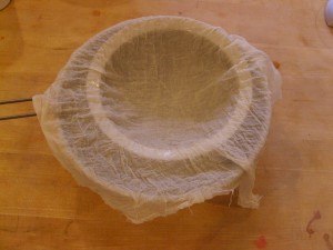 Cheesecloth on strainer over bowl